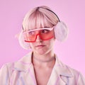 Woman, fashion and unique on a pink background in studio with funny glasses for cyberpunk style. Face of edgy, trendy or