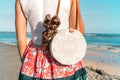 Woman with fashionable stylish rattan bag and silk scarf outside. Tropical island of Bali, Indonesia. Rattan handbag and Royalty Free Stock Photo