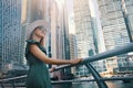 Woman in fashionable summer dress and hat enjoying Dubai marina views with skyscrapers in United Arab Emirates Royalty Free Stock Photo