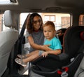 Woman fastening her son with car safety belt Royalty Free Stock Photo