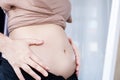 woman with fat abdominal, overweight female belly checking her body in front of a mirror Royalty Free Stock Photo