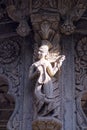 A woman feather cap on her head and wings to her carved in stone on the wall of chhatriMemorial at Maheshwar