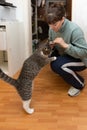 woman feed a cat