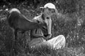 Woman feed fawn deer. Unity with nature. Wild animals concept. Girl feeding bambi. Animal at park. Royalty Free Stock Photo