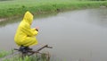 Woman feed fish rain