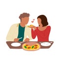 Woman feeding her boyfriend pizza in pizzeria