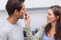 Woman feeding her husband cherry tomato Royalty Free Stock Photo