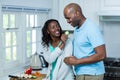 Woman feeding man a slice of cucumber Royalty Free Stock Photo