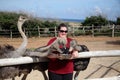 Woman feeding ostrich