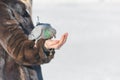 A woman is feeding pigeons from her hands. Feed birds in winter with hands. Royalty Free Stock Photo