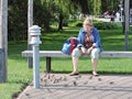 Woman feeding sparrow birds