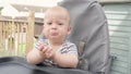 Woman feeding Tired child with spoon. Mom feed crying Sad baby Boy with pureed food. Mom feeding kid in baby chair Royalty Free Stock Photo