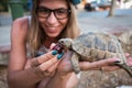 Woman feeding turtle