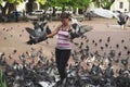 Woman feeds pigeons in Santo Domingo, Dominican Republic.