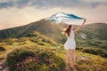 Woman feel freedom and enjoying the mountain nature at sunset