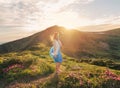 Woman feel freedom and enjoying the mountaine nature at sunset