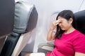 Woman feel headache in airplane Royalty Free Stock Photo