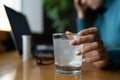 Woman feel sick in office wait for pill tablet dissolving in water glass. Ill female take medication Royalty Free Stock Photo