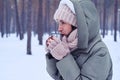 Woman feeling cold and drinking hot tea to warm up Royalty Free Stock Photo