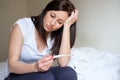 Woman feeling depressed and sad after looking at pregnancy test