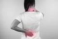 A woman feeling exhausted and suffering from neck and back pain and injury on white background. Health care and medical concept