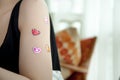 Woman feeling happily in love with heart stickers on her arms Royalty Free Stock Photo