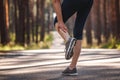 Woman feeling pain of her leg during jogging