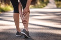 Woman feeling pain of her legs during jogging