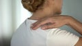 Woman feeling pain in shoulder after workout, muscle soreness, health care