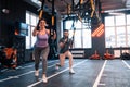 Overweight woman feeling positive while exercising with TRX Royalty Free Stock Photo