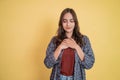 a woman feeling relaxed with her eyes closed with a hand gesture holding her chest while standing Royalty Free Stock Photo