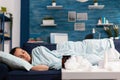 Woman feeling sick sleeping at home on the couch Royalty Free Stock Photo