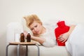 Woman feeling stomach cramps lying on cofa Royalty Free Stock Photo