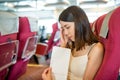 Woman feeling unwell and vomit on paper bag inside ferry Royalty Free Stock Photo