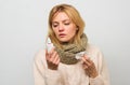 Woman feels badly ill sneezing. Girl in scarf hold nasal spray and tissue. Cold and flu remedies. Runny nose and other Royalty Free Stock Photo