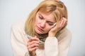 Woman feels badly ill sneezing. Girl in scarf hold thermometer and tissue close up. Measure temperature. Break fever Royalty Free Stock Photo