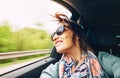 Woman feels free and looks out from open window car Royalty Free Stock Photo