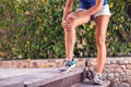 Woman feels strong knee pain while doing exercises. People, healthcare and medicine concept Royalty Free Stock Photo