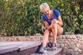 Woman feels strong knee pain while doing exercises. People, healthcare and medicine concept Royalty Free Stock Photo