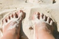 Woman feet covered with white sand at the beach Royalty Free Stock Photo