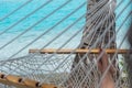 Woman feet in hammock on the beach, blue sea background, Aitutaki Royalty Free Stock Photo