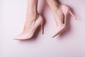 Woman feet in pink shoes closeup with small spider veins, leg disease. Unhealthy side effect of wearing high heels that provokes