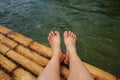 Woman feet relaxing on bamboo raft floats in the river Royalty Free Stock Photo