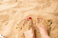 Woman feet on the sand