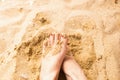 Woman feet on the sand