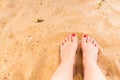 Woman feet on the sand