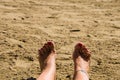 Woman feet in the sand with red painted nails Royalty Free Stock Photo