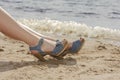 Woman feet in sandals on the beach Royalty Free Stock Photo