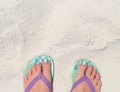 Woman feet in slippers on beach. Young woman tourist by sea. Seaside banner template with text place. Royalty Free Stock Photo