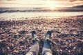 Woman Feet sneakers on beach sea sunset